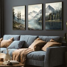 a living room with three paintings on the wall and a couch in front of it