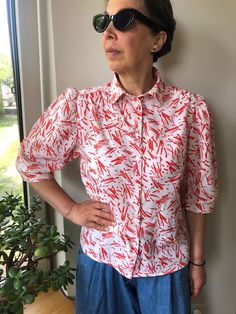 Vintage 80s white and red abstract print short sleeve blouse. Puff sleeve front buttoned blouse. Collared blouse. Summer women's outfit. Cotton colourful blouse. Marked as size 40. 100% cotton. From shoulder to shoulder 15,5" 39cm Bust 40" 102cm Sleeve length 15" 38cm Length 24" 61cm. Trendy Fitted Button-up Shirt, Summer Slim Fit Button-up Tops, Slim Fit Button-up Tops For Summer, Non-stretch Short Sleeve Summer Shirt, Summer Slim Fit Buttoned Tops, Summer Slim Fit Tops With Button Closure, Slim Fit Tops With Button Closure For Summer, Red Slim Fit Shirt For Spring, Non-stretch Printed White Blouse