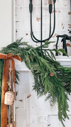 a christmas garland hanging from a fireplace mantel