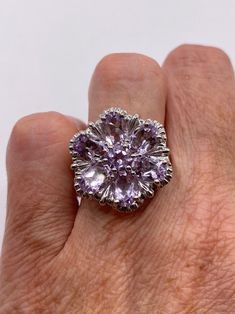 This is a vintage purple amethyst flower ring   set in 925 sterling We have in size 6.5  this can be sized to your specification, our jeweler charges $20 please message us to discuss sizing your ring or engraving options. All of our jewelry is hand polished and shipped to you in a stylish gift box.  We are happy to gift wrap for you.  It is important to us that each customer be thrilled with their purchase.  We are grateful for thousands of positive reviews. Purple Flower-shaped Formal Jewelry, Elegant Amethyst Flower Ring For Anniversary, Elegant Purple Amethyst Flower Ring, Amethyst Gemstone Flower Ring For Anniversary, Anniversary Amethyst Gemstone Flower Ring, Elegant Purple Flower Ring As A Gift, Elegant Purple Gemstone Flower Ring, Elegant Purple Flower Ring For Gift, Elegant Purple Flower Ring As Gift