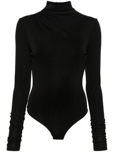 a woman wearing a black bodysuit with long sleeves