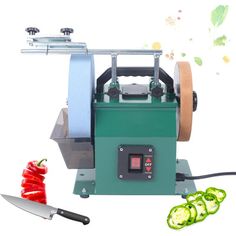 an image of a machine that is cutting peppers with a knife and some sliced cucumbers next to it