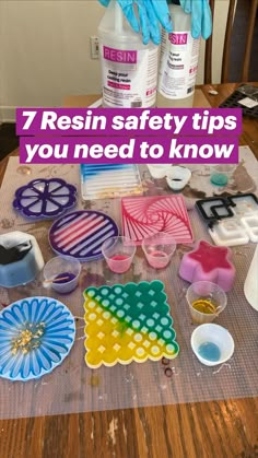 a table topped with lots of crafting supplies on top of a wooden table covered in blue gloves