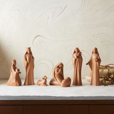 wooden nativity figurines sitting on top of a counter