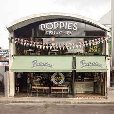 an outside view of a restaurant called poppies fish and chips