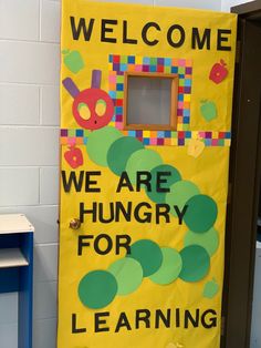 the very hungry caterpillar door is decorated with words and pictures to welcome children