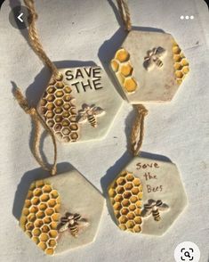 four ceramic tags with bees and save the bees written on them