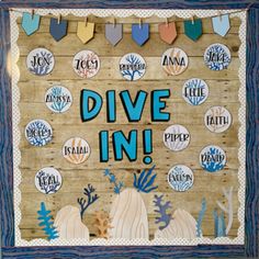 a sign that says dive in on the side of a wooden board with sea life around it