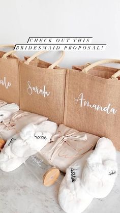 the bridesmaid's personalized bags are lined up on top of each other