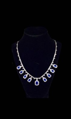 "The past will always return in the fashion world and this piece is back for round two! In the 1920's ladies of class wore the most opulent dresses with jewelry to match. As the years continued, jewelry makers tailored pieces to fashion and trends which resulted in affordability for style. Presenting this Absolutely Show Stopping Vintage 30 Carat Cobalt Tanzanite Estate Necklace Featuring Elegant Teardrop Gemstone Designs With White Sapphire Accents. This is a wonderful example of the great Crow Elegant Sapphire Drop Necklaces, Elegant Sapphire Pear-shaped Necklace, Elegant Pear-shaped Sapphire Necklace, Formal Sapphire Drop Jewelry, Formal Drop Sapphire Jewelry, Elegant Sapphire Necklaces For Evening, Formal Sapphire Drop Necklaces, Elegant Sapphire Necklace For Evening, Formal Sapphire Pear-shaped Necklace