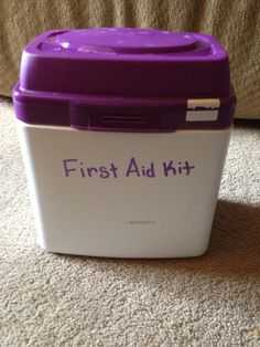 a purple and white first aid kit sitting on the floor