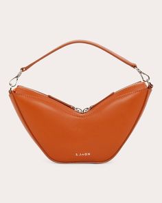 A nod to '90s baguette styles, the Mini Tulip Bag embraces functional luxury with its calf leather body, polished silver-tone hardware and soft suede lining. Carry this bite-sized bag by the top handle or detachable crossbody strap for maximum versatility.Includes detachable crossbody strapZip closureSilver-tone hardwareOuter: 100% calf leatherLining: 100% suedeSpecialist cleanMade in Italy Measurements Width: 8.66in Height: 4.72in Depth: 1.97in Handle drop: 3.15in Detachable strap drop: 19.69in Tulip Bag, Baguette Bag, Polish Silver, Personal Shopping, Soft Suede, Crossbody Strap, You Bag, Burnt Orange, Baguette