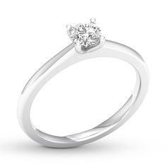 a white gold ring with a single diamond