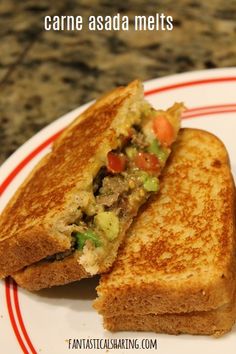 a grilled sandwich on a white plate with red trim