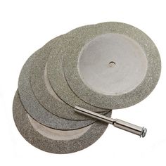 four grinding discs with one holding a tool