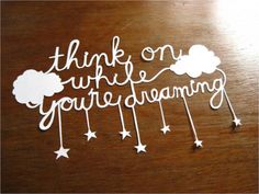 the words think on what you're dreaming are written in white paper with stars