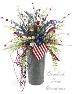 a vase filled with flowers and an american flag