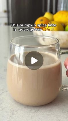 someone holding a glass mug filled with liquid