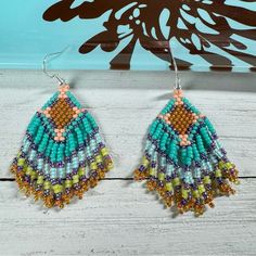 Handmade Seed Bead Beaded Earrings Native American Themed 2.5” Long Multicolor Add A Touch Of Boho Chic To Your Look With Our Handmade Seed Beaded Fringe Earrings. These Lightweight Earrings Are Not Only Stylish But Also Comfortable To Wear All Day Long. With Their Vibrant Multicolored Beads, They Bring A Playful And Eye-Catching Element To Any Ensemble. Beads Used - Miyuki Colors - Turquoise, Mint Turquoise Lined, Chartreuse, Lime, Peach, Amethyst Measurements Drop Length - 2 Inches Length With Blue Bohemian Beaded Earrings With Large Beads, Bohemian Blue Beaded Earrings With Large Beads, Artisan Blue Beaded Earrings With Colorful Beads, Colorful Beaded Brown Earrings For Beach, Beach Beaded Earrings With Colorful Beads, Brown Beaded Earrings For The Beach, Brown Round Beads Earrings For Beach, Brown Beaded Earrings For Beach, Brown Round Beaded Earrings For Beach