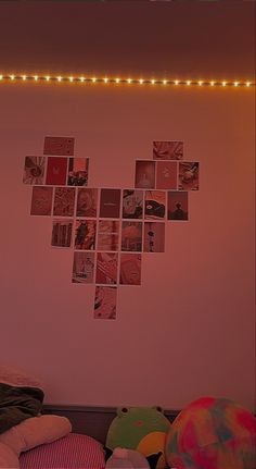 a bedroom with pink walls and pictures on the wall