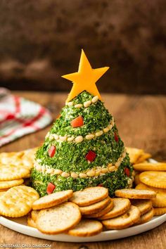 a christmas tree made out of cheese crackers on a plate with a star decoration