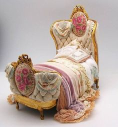 an old fashioned bed with pink flowers on the headboard and foot board, made out of fabric