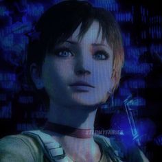 a woman with short hair and blue eyes is standing in front of a computer screen