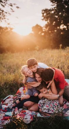 a group of people that are sitting on a blanket