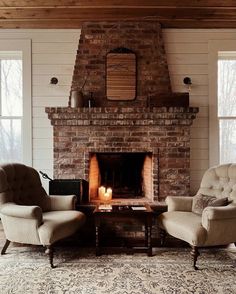 a living room with two chairs and a fire place