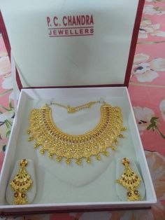 a necklace and earring set in a box