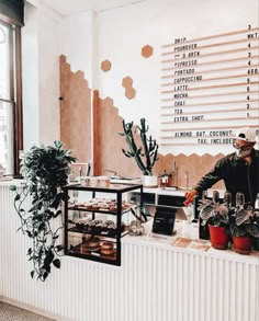 a man standing behind a counter filled with food