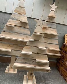 two wooden christmas trees sitting next to each other