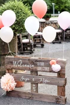 some balloons are in the air near a wooden box