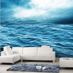 a living room scene with the ocean and sky painted on it's wallpaper