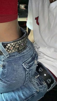 the back of a person's jeans showing their butts and thighs with an embellishment on them