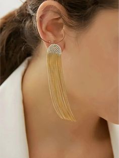 Introducing the 18k Gold Plated Tassel Earrings from Furano Studio – a dazzling display of elegance and flair. These long drop earrings feature delicate tassels that dance with every movement, catching the light and drawing eyes. Their luxurious 18k gold plating ensures a radiant glow and enduring beauty. Perfect for both special events and adding a touch of glamour to your everyday look, these earrings are a must-have for the fashion-forward individual. Additional Details: Product Type: Earrings Color: Gold Material: 18k Gold Plated Features: Elegant Tassels, Long Drop Design Care: Store in a dry place, avoid direct contact with chemicals Elegant Fringe Jewelry For Weddings, Elegant Fringed Jewelry For Weddings, Elegant Long Drop Tassel Earrings For Gift, Elegant Long Drop Tassel Earrings, Elegant Tassel Dangle Earrings For Pierced Ears, Elegant Dangle Tassel Earrings For Pierced Ears, Elegant Chandelier Earrings With Tassels, Elegant Silver Earrings With Tassels, Elegant Tassel Chandelier Earrings