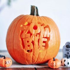 a carved pumpkin with the word mom and baby spelled in it, surrounded by halloween decorations