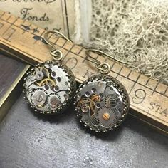 Jane, Vintage Watch Movement Earrings  #reimagined #victorianjewelry #vintagejewelry #industrialdesign #handmadejewelry #artjewelry #statementjewelry #steampunkfashion #mythological #localartist Steampunk Antique Gold Metal Jewelry, Silver Steampunk Earrings, Handmade Brass Steampunk Earrings, Steampunk Metal Jewelry With Vintage Charm, Moon Goddess Necklace, Nickel-free Brass Steampunk Jewelry, Goddess Necklace, Bird Pendant, Watches Unique