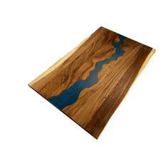 a wooden cutting board with blue lines on the edge and wood grain inlays