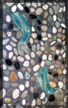 a mosaic tile with rocks and fish on it's side, in the shape of pebbles