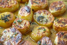 baked potatoes with herbs and sauce in a pan