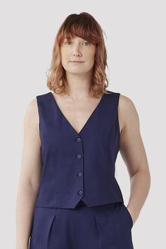 The Wool Vest by Aam is a chic Classic Fitted Vest Top, Classic Stretch Vest For Spring, Fitted Vest For Workwear In Summer, Summer Cropped Workwear Vest, Summer Workwear Cropped Vest, Cropped Summer Workwear Vest, Tailored Cropped Tops For Workwear, Classic Fitted Formal Tank Top, Fitted V-neck Tank Top For Work