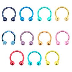 six pairs of colorful metal nose rings with bells on each one side and four different colors