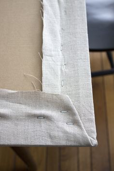 the fabric has been stitched together with pins and needles to make a table runner