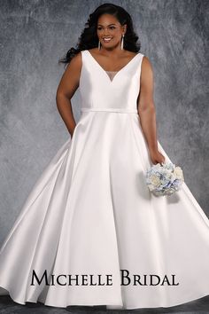 a woman in a white wedding dress posing for a photo with her hands on her hips