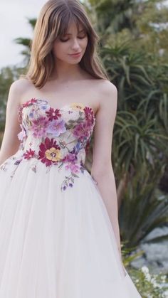 a woman in a white dress with flowers on it