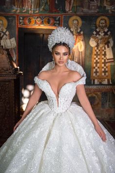 a woman in a wedding dress posing for the camera with her hands on her hips