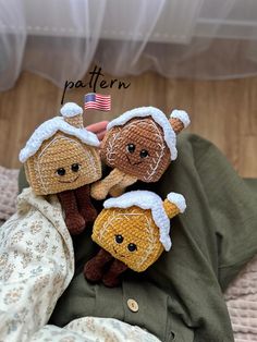 two little stuffed animals are sitting next to each other on a blanket with the american flag in the background