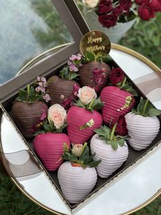 a box filled with chocolate covered strawberries on top of a table