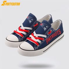 pair of new england football shoes with red, white and blue laces on them